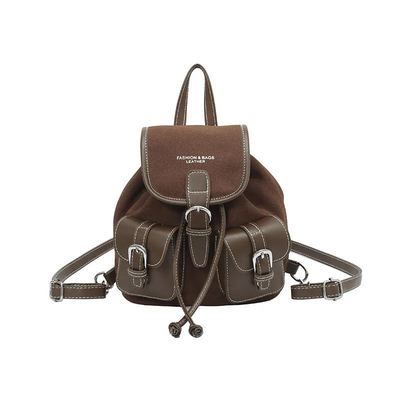 Urban simplicity PU backpack in brown with contrast stitching and clamshell opening, on a flat surface
