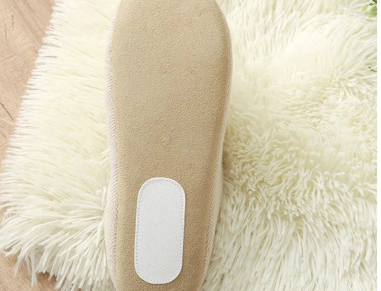 Men's cotton black indoor slippers with anti-skid sole on a home floor