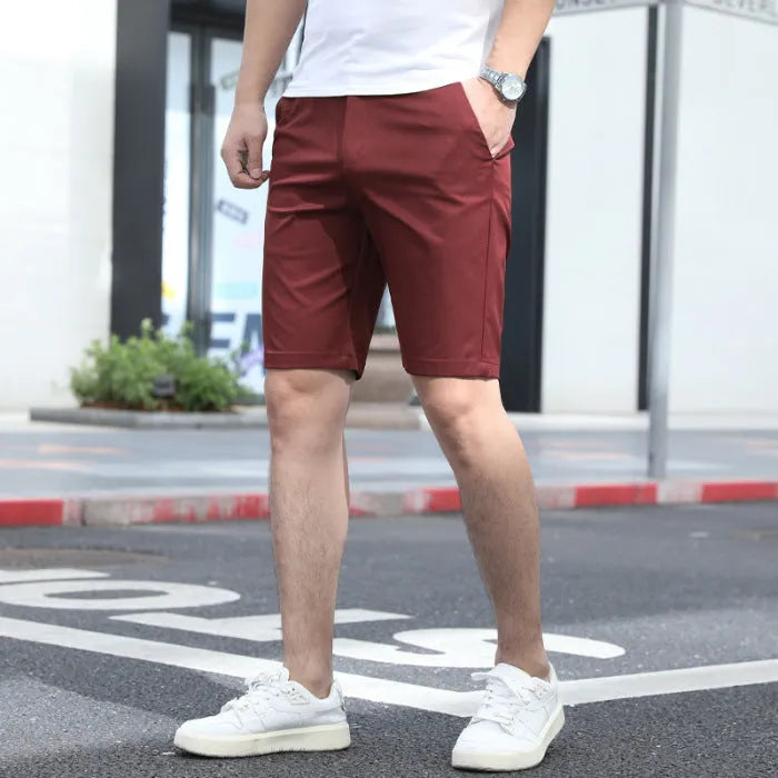Men's loose elastic fifth pants in solid colour polyester fabric on a size chart