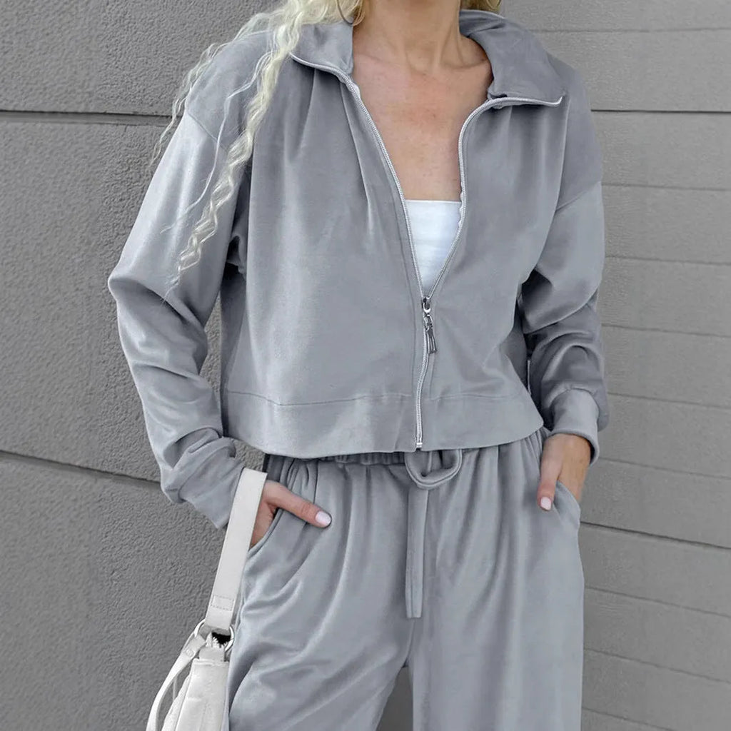 Women's velvet-look two-piece suit with drop-shoulder top and full-length trousers, available in grey or pink, sizes S to L