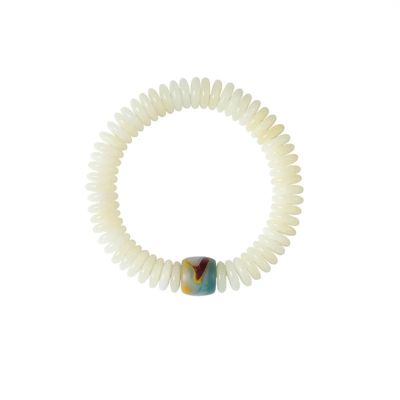 White Bodhi seed bracelet and handheld mala with 3x10mm beads on a neutral background.
