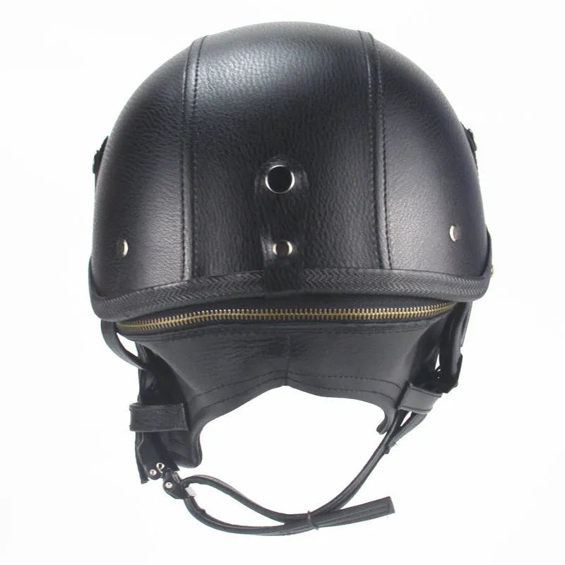Black retro handmade leather half helmet for motorcycles on a plain background.