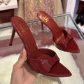 Women's black patent leather stiletto sandals with 8cm heel, pointed toe, and ankle strap