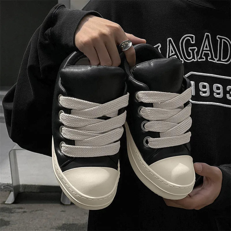 Men's black leather slip-on casual shoes with flat rubber sole and round toe on a white background.