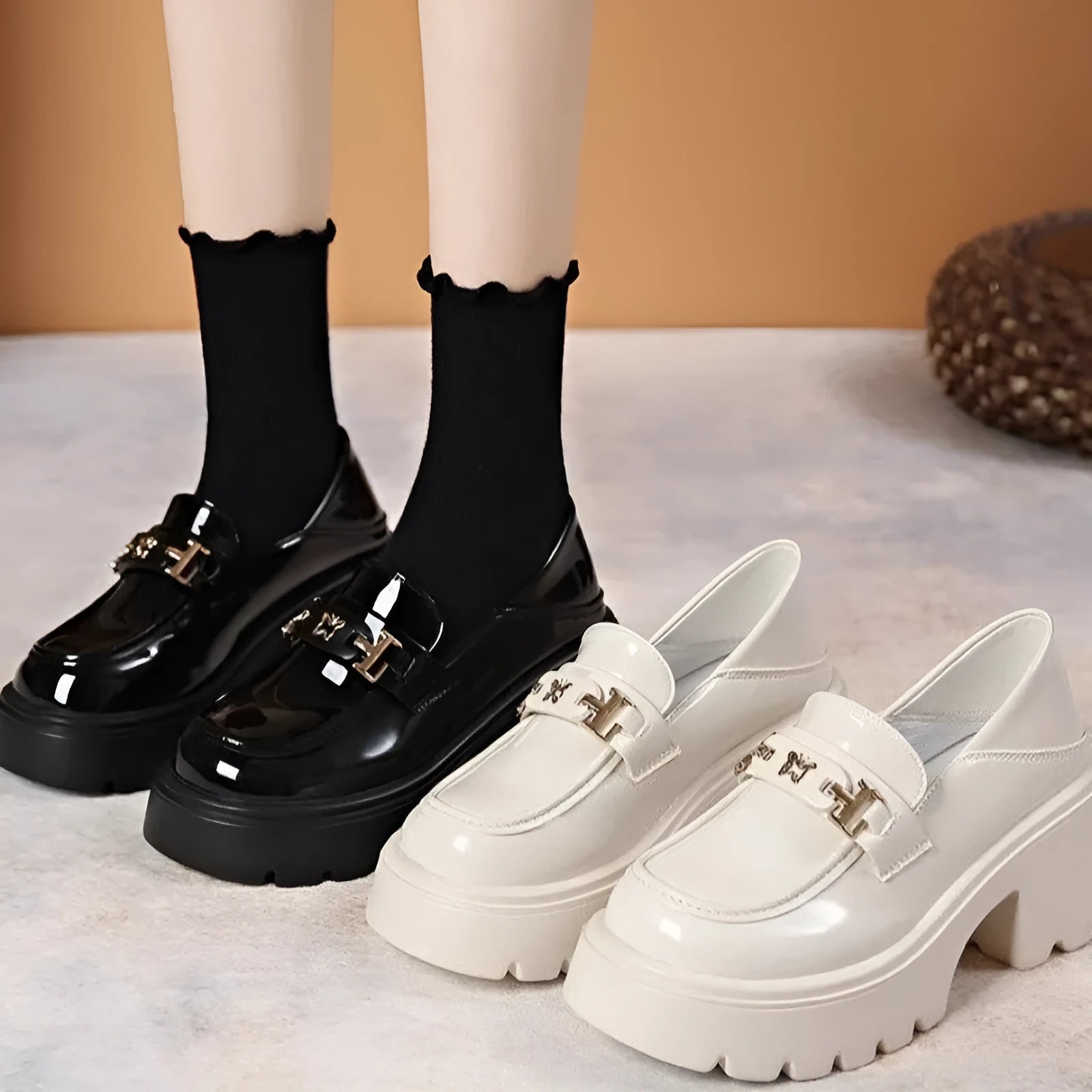 Black women's slip-on shoes with a skull pattern, chunky square heel, and round toe on a white background.