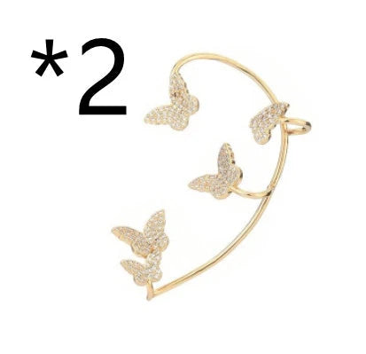 Sparkling zircon butterfly ear cuffs in gold-toned metal, featuring a delicate and elegant design for stylish accessorizing