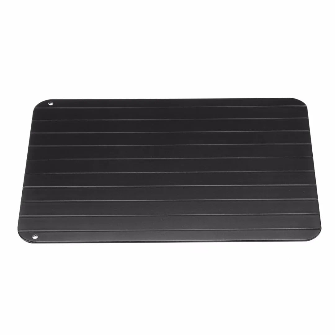 Black aluminium fast defrosting tray for kitchen use on a countertop
