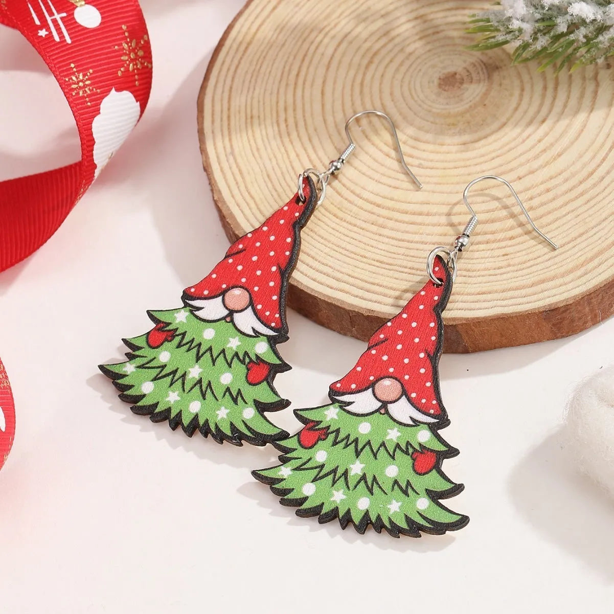 Wooden Christmas earrings showing Christmas tree and water drop snowman designs with geometric shapes