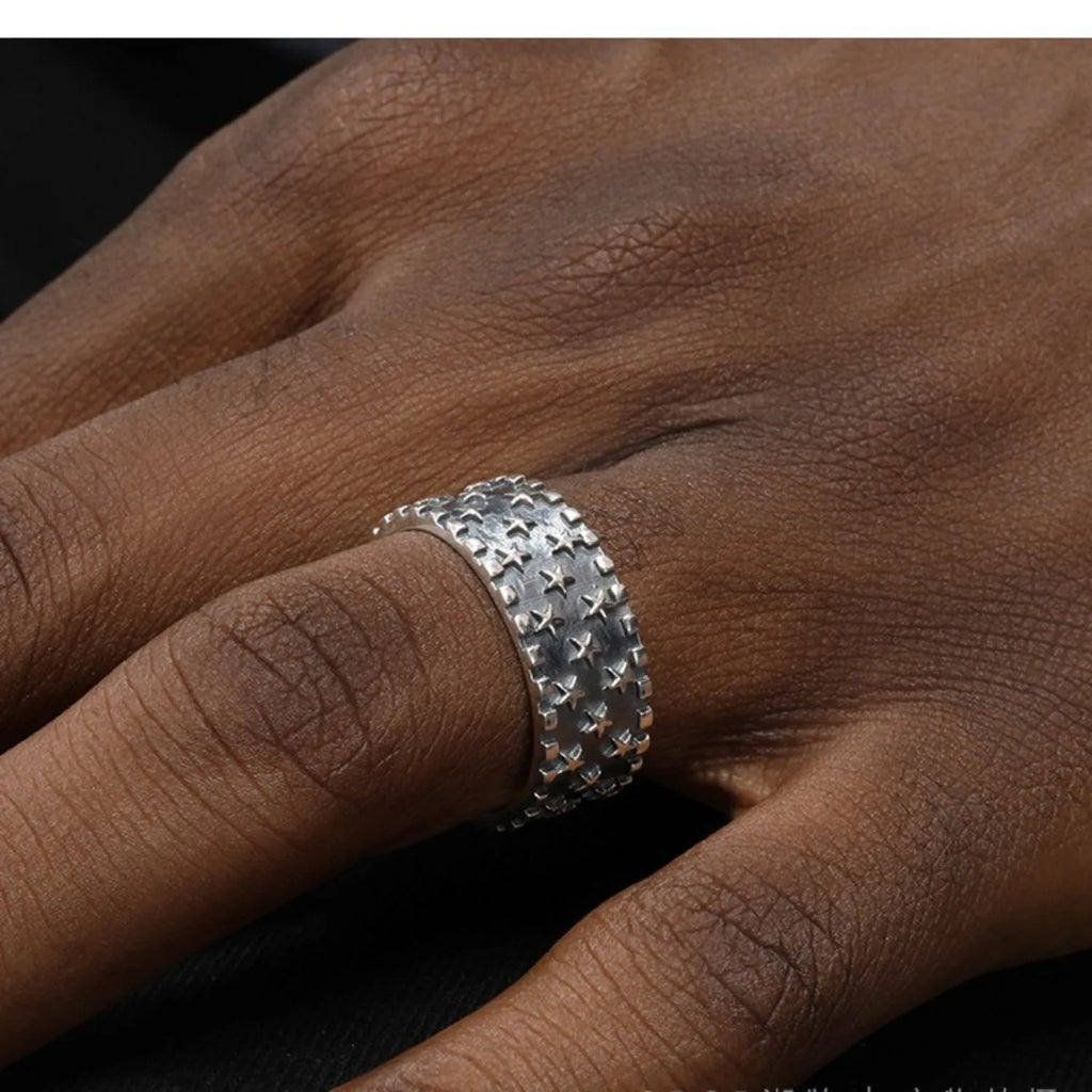 Adjustable sterling silver ring with geometric five-pointed star design on finger