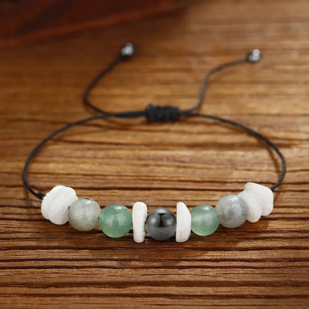 A handcrafted women's bracelet with geometric stone beads in colour 3906 on a wrist.