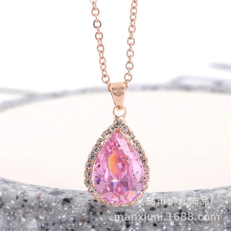 Women's pink alloy water drop necklace with geometric design and rose gold rhinestones on model