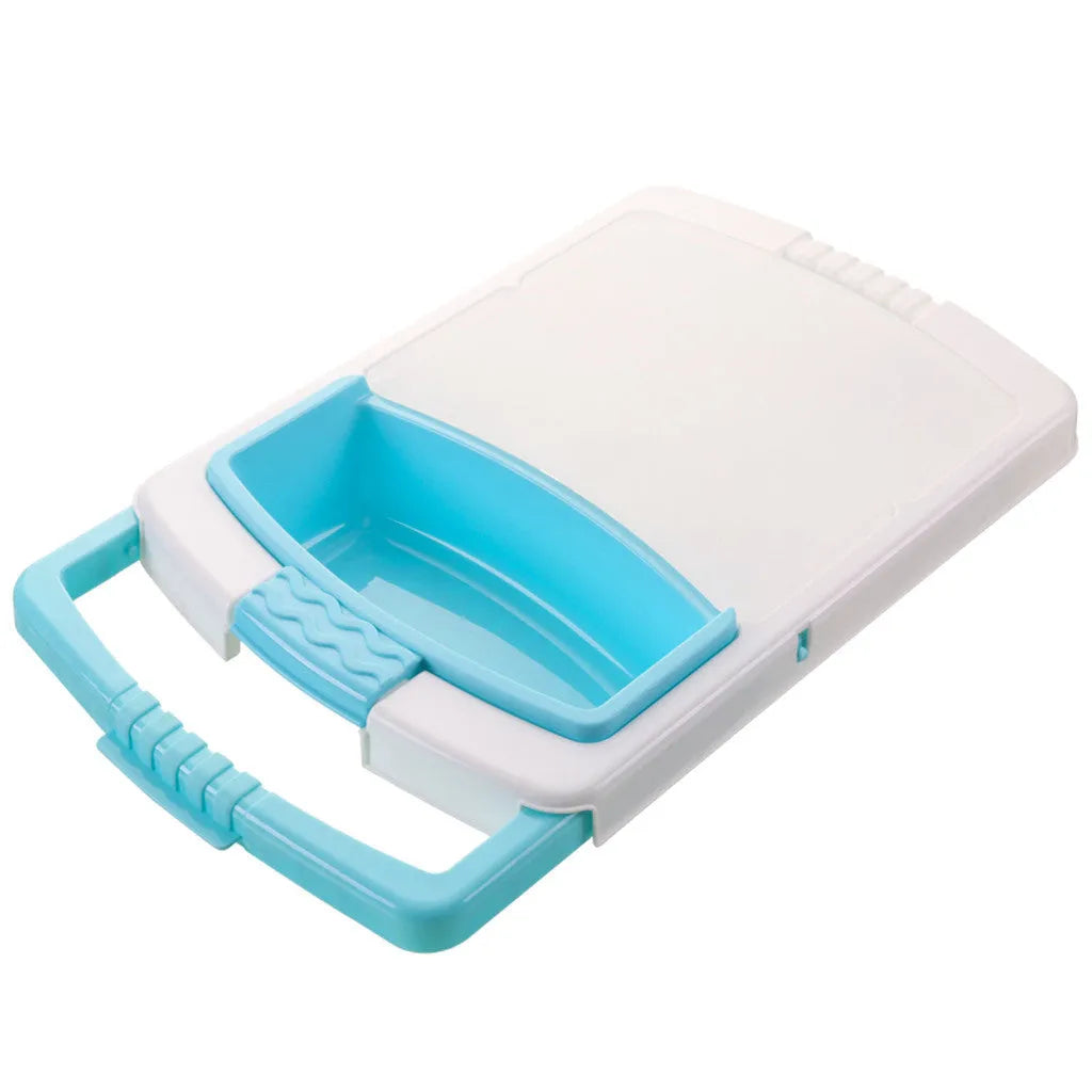 Green sink-mounted kitchen cutting board with drain holes and a storage trough for vegetables.