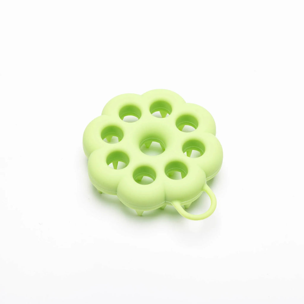 Silicone pet grooming brush in multiple colours for dogs and cats, showing flexible bristles.