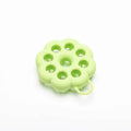 Silicone pet grooming brush in multiple colours for dogs and cats, showing flexible bristles.