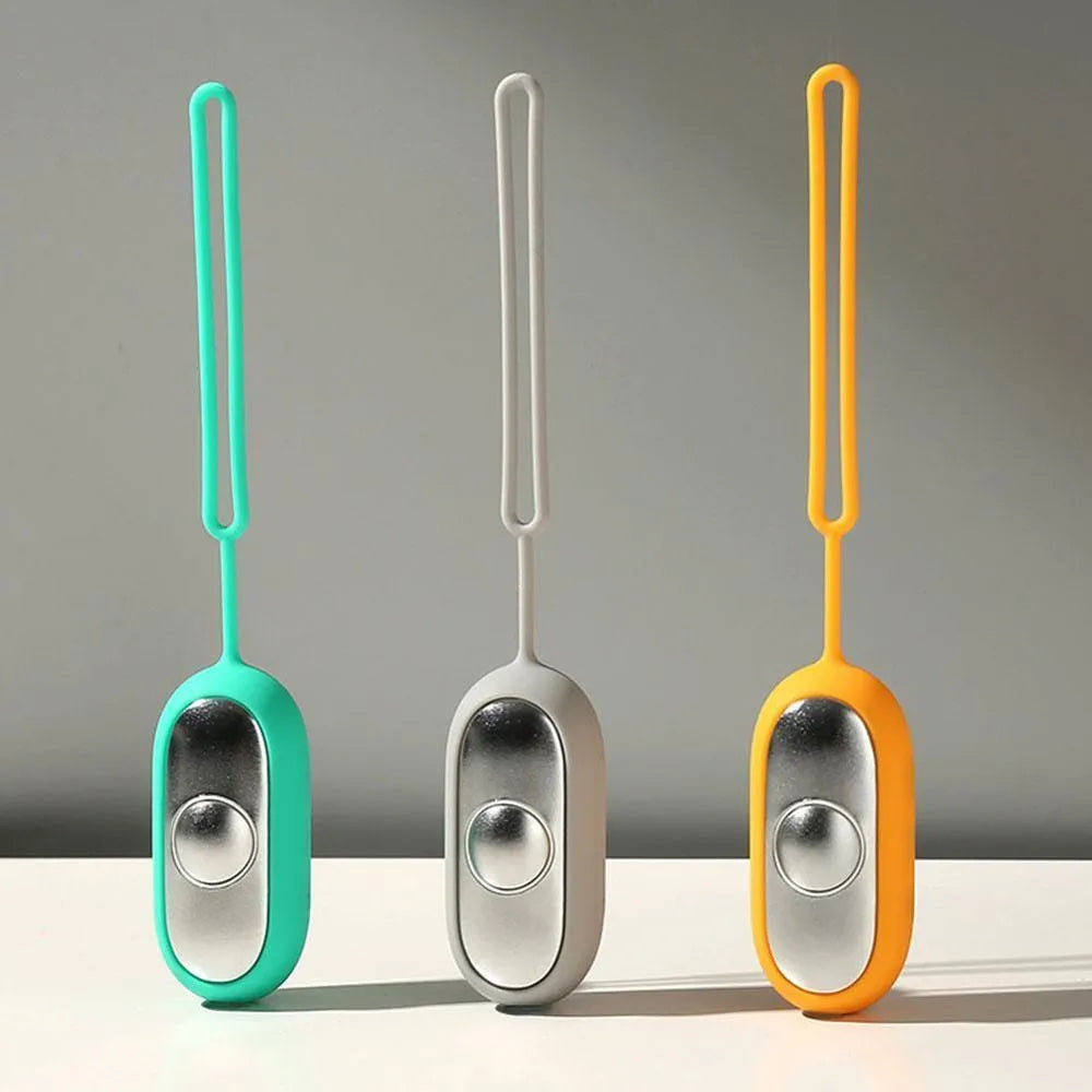 Handheld micro-current sleep aid device in grey, green, or orange colour with USB charging cable.