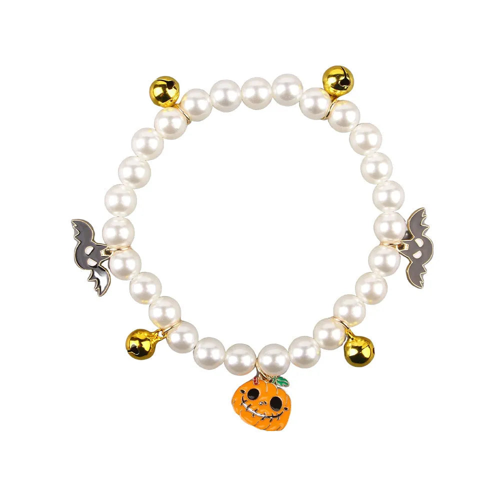 Halloween cat collar with simulated pearl necklace and pumpkin designs including purple ghost, skull, and smiling patterns