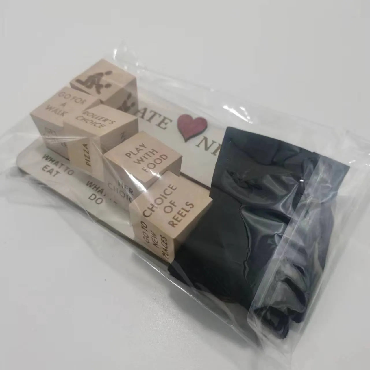Wooden date night dice game set for couples showing five dice, a wooden planner board and a black storage bag.