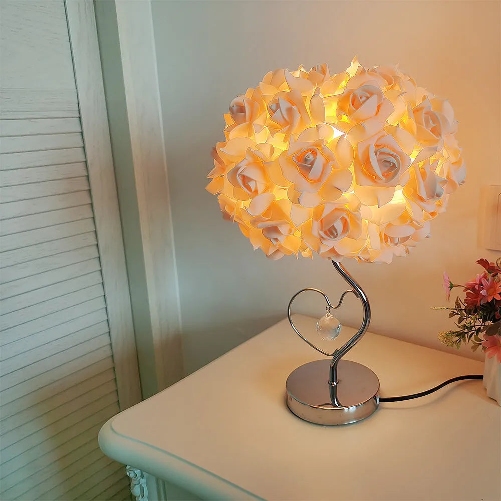 Heart-shaped crystal table lamp with metal holder, apricot colour, on bedside table