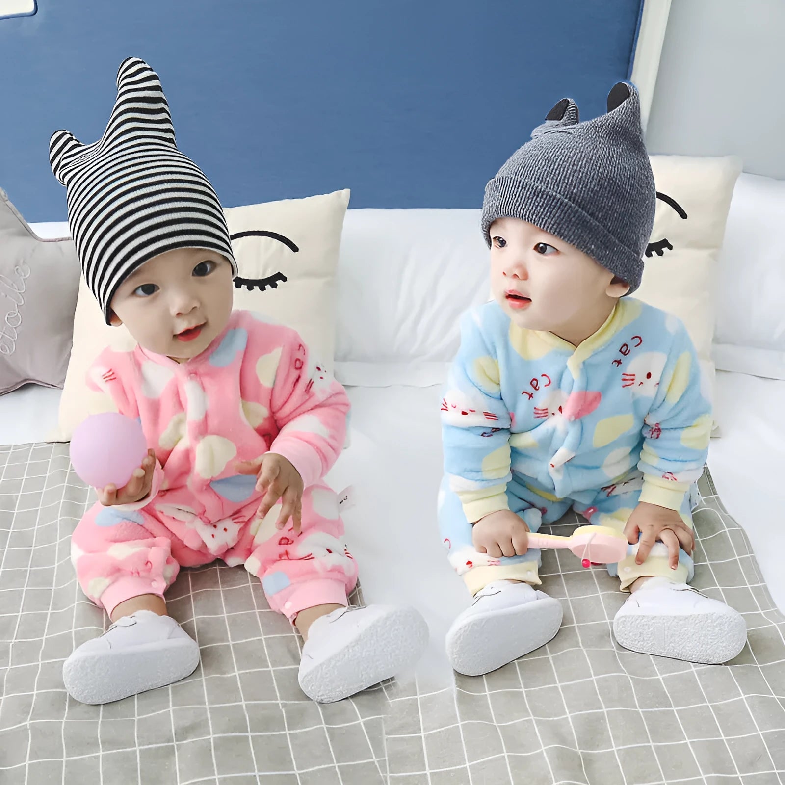 A baby wearing a long sleeve cotton flannel romper in a pink pineapple print pattern.