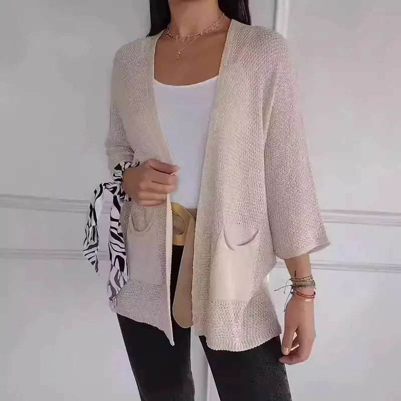 Women's waffle-knit cardigan coat in army green, showing texture and pocket detail.