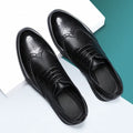 Men's black brogue leather shoes with traditional wingtip design and perforated patterns