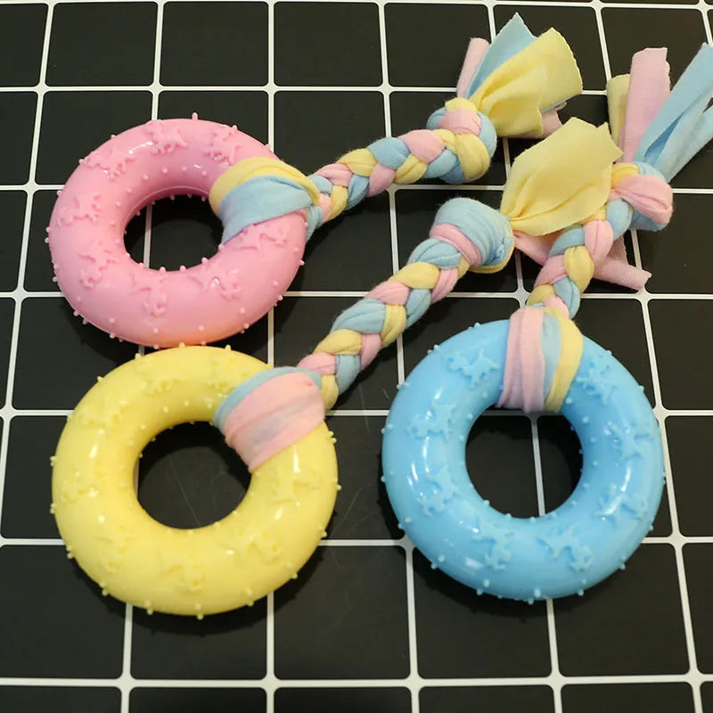 Non-toxic rubber dog chew toy with surface particles, star ring ball shapes, pink blue yellow