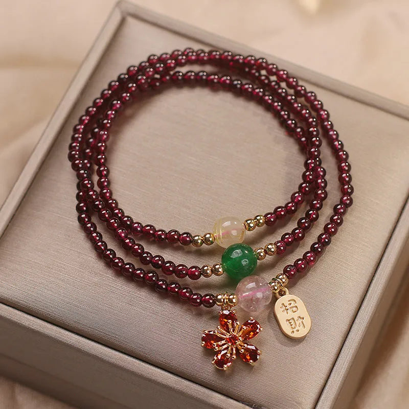 Crystal bracelet for women in pomegranate red cherry blossom colour with sequin details.