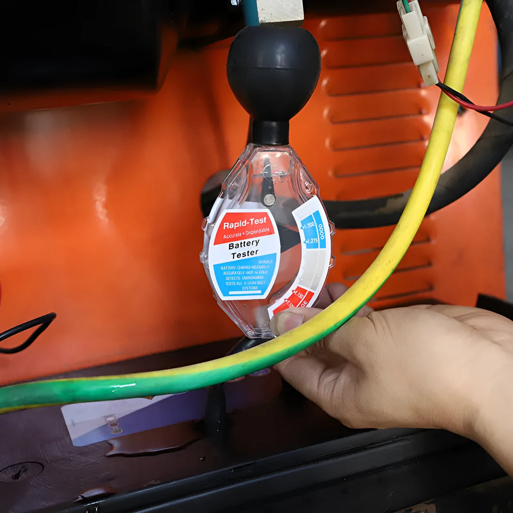 ABS plastic suction electrolyte hydrometer tool for lead-acid battery testing on a workbench.