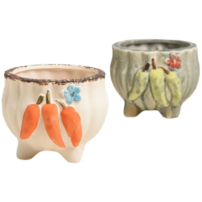 Three breathable stoneware succulent flower pots in hand-painted glaze colours on a tabletop with small succulents inside
