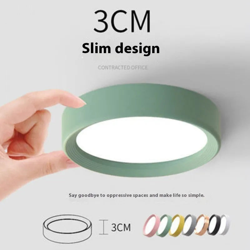 Ultra-thin surface mounted LED downlight in a choice of seven colours including black, white, gold, and pink.