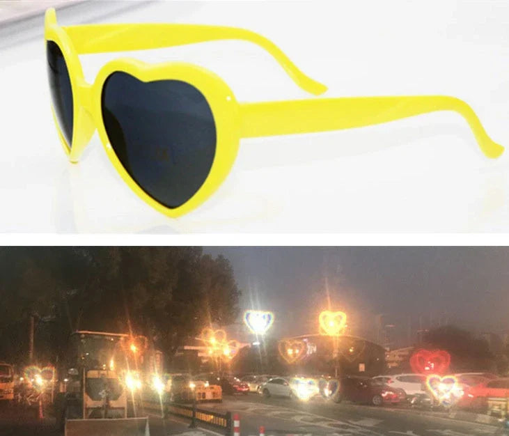 Heart-shaped glow-in-the-dark sunglasses in various vibrant colors, featuring a durable plastic frame and resin lenses for reliable UV protection.