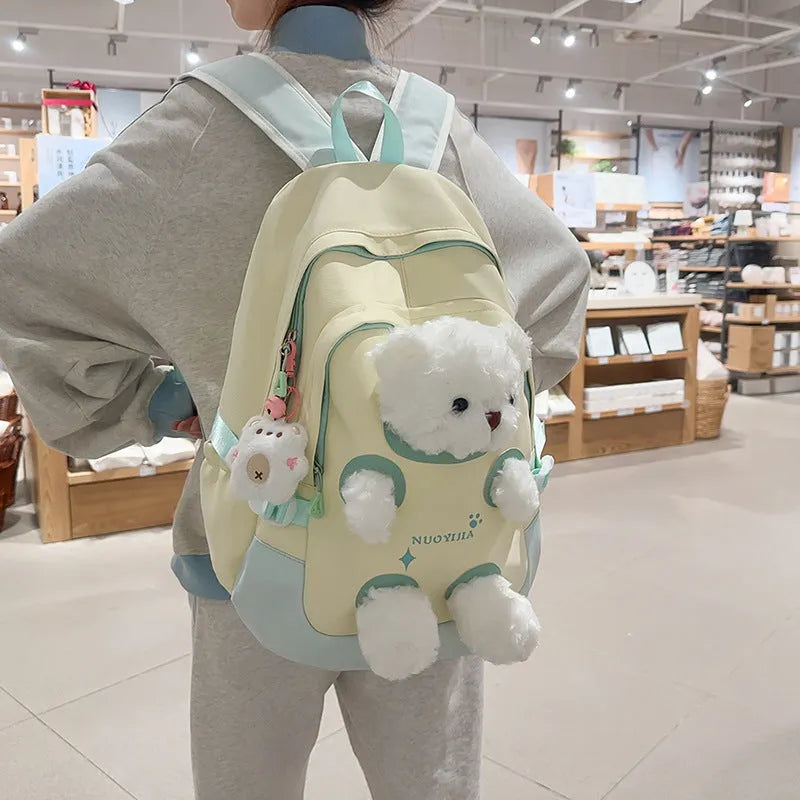 Yellow pink nylon backpack with bear design and curved shoulder straps, 20-35L capacity.