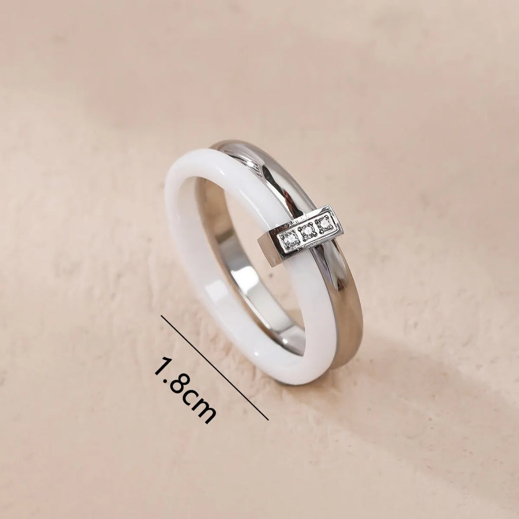 Women's titanium steel heart-shaped double ring with glossy stitching and inlaid zirconium stones in three colour options.