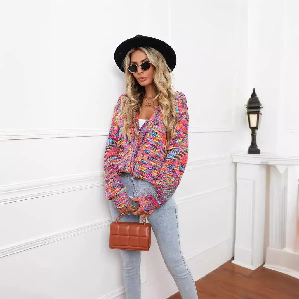 Rose red women's short cardigan with rainbow festival stripes, loose fit, worn open as a coat.