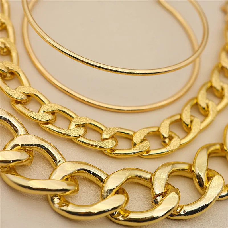 Three gold alloy double-layer thick chain bracelets with geometric design laid out flat