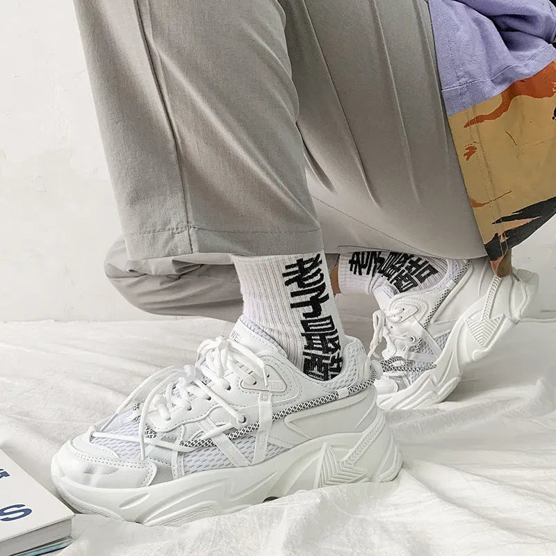 Men's white platform dad shoes with lace-up front and mesh lining on a neutral background.