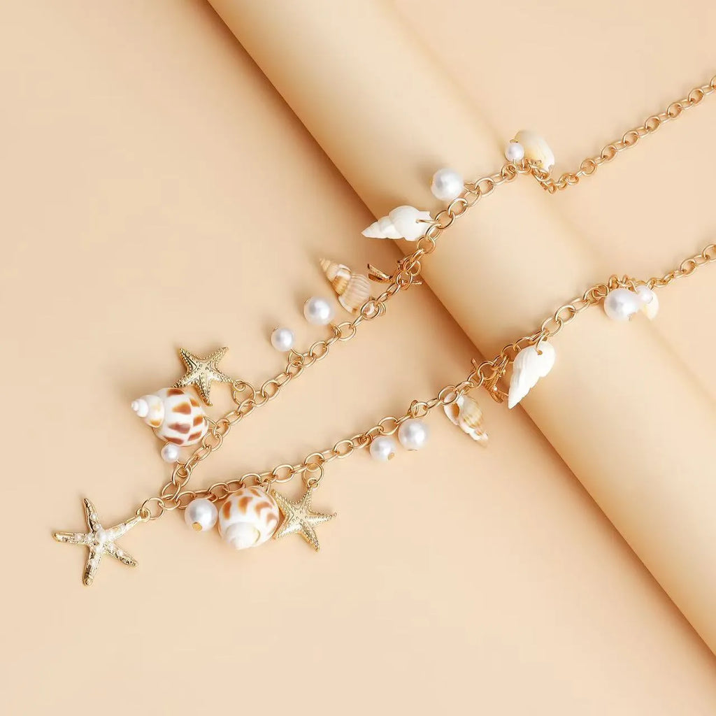 Women's alloy star charm waist chain and matching bracelet jewellery set on white background