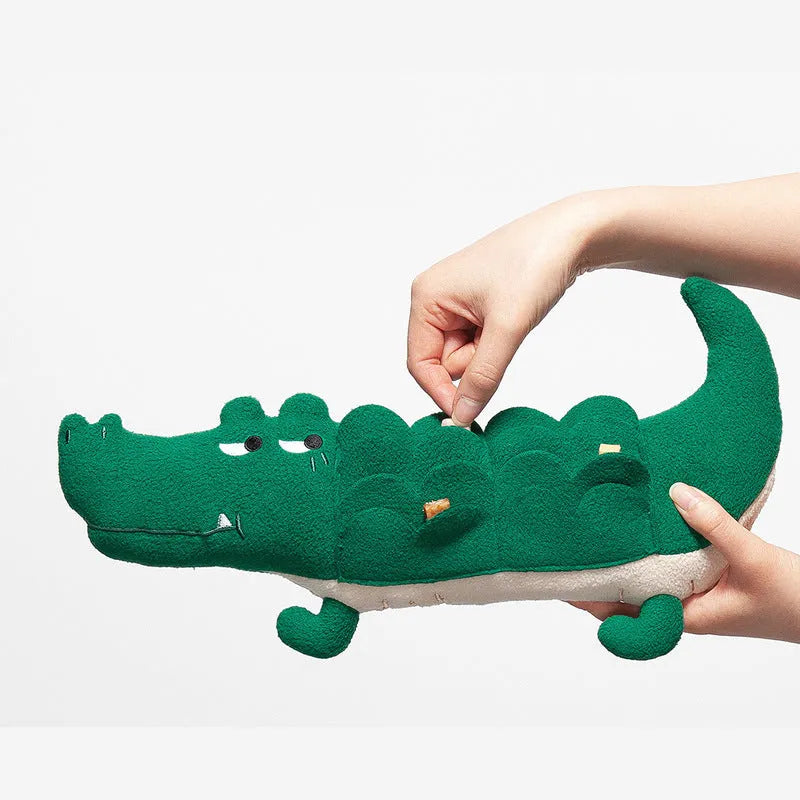 Green plush stuffed toy dog on white background, showing soft texture and size.
