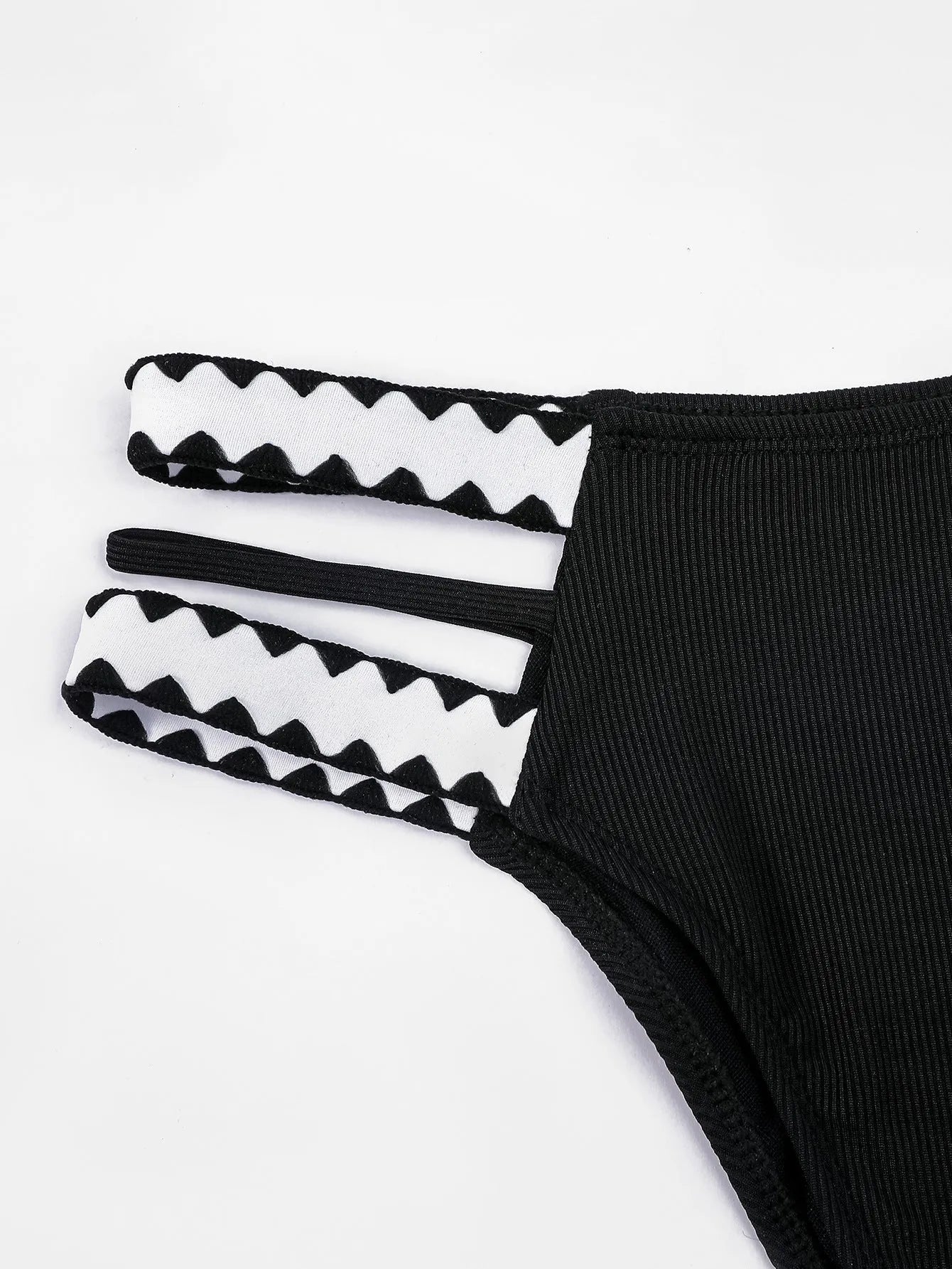 Black women's hollowed-out split swimsuit bikini set on a mannequin.