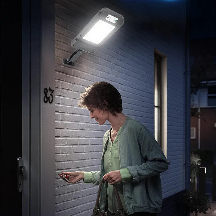 Grey solar wall light with 160COB lamp beads and induction sensor mounted on brick wall