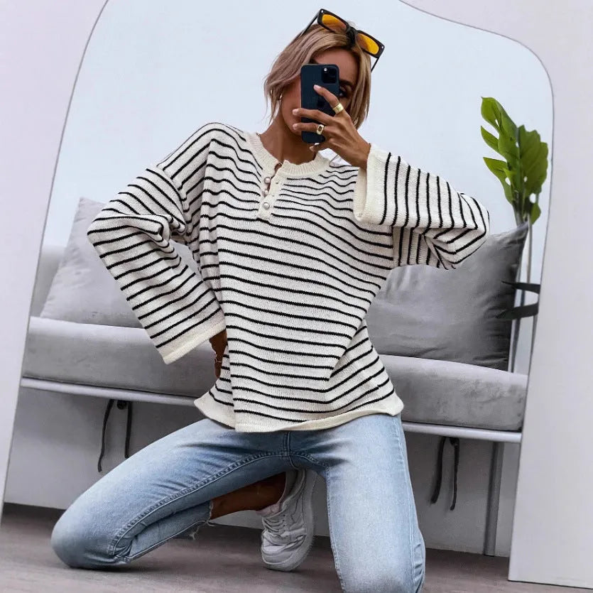 Black striped women's casual top with drop shoulders and button detailing