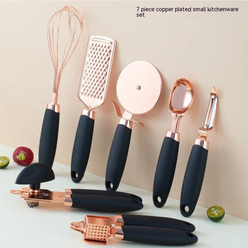 Seven-piece stainless steel kitchen tool set with copper plating on a matching storage rack.
