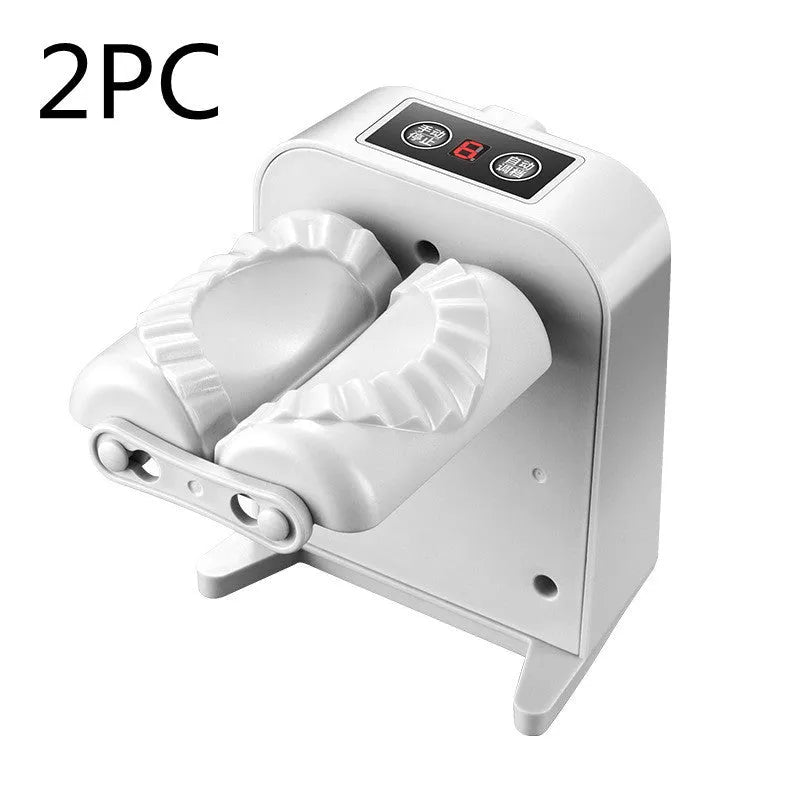 White automatic electric dumpling maker machine with USB cable and accessories on a kitchen counter.