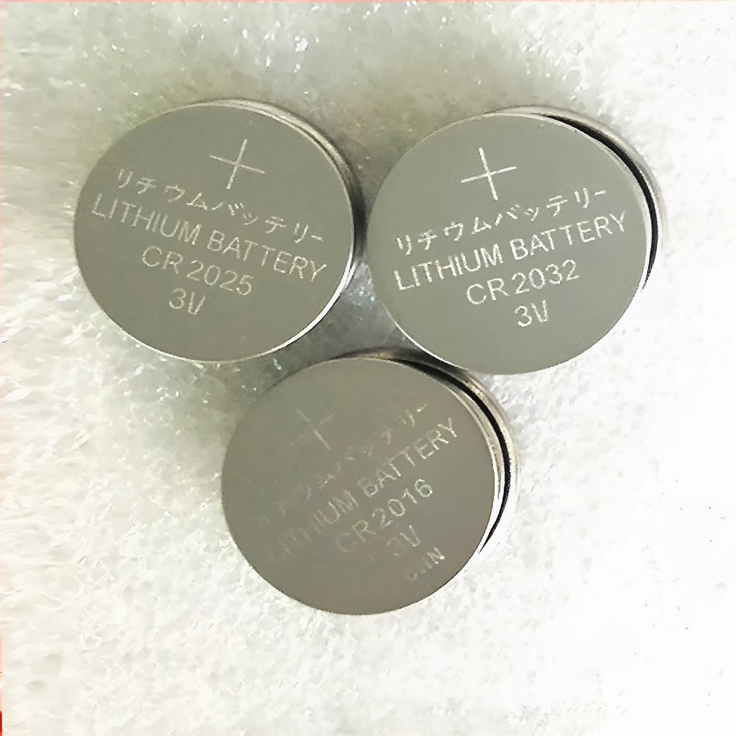 Pack of 3V button cell batteries showing CR2032, CR2025, and CR2016 sizes for small electronics.