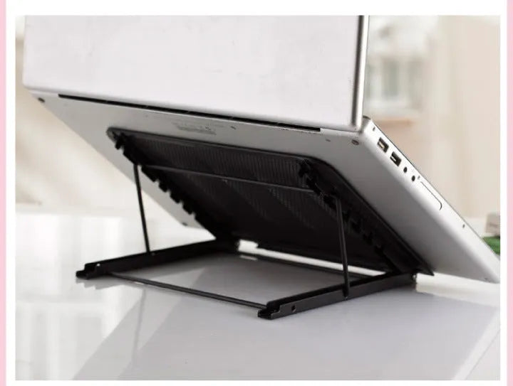 Adjustable folding laptop stand in silver, shown at an angle supporting a laptop.
