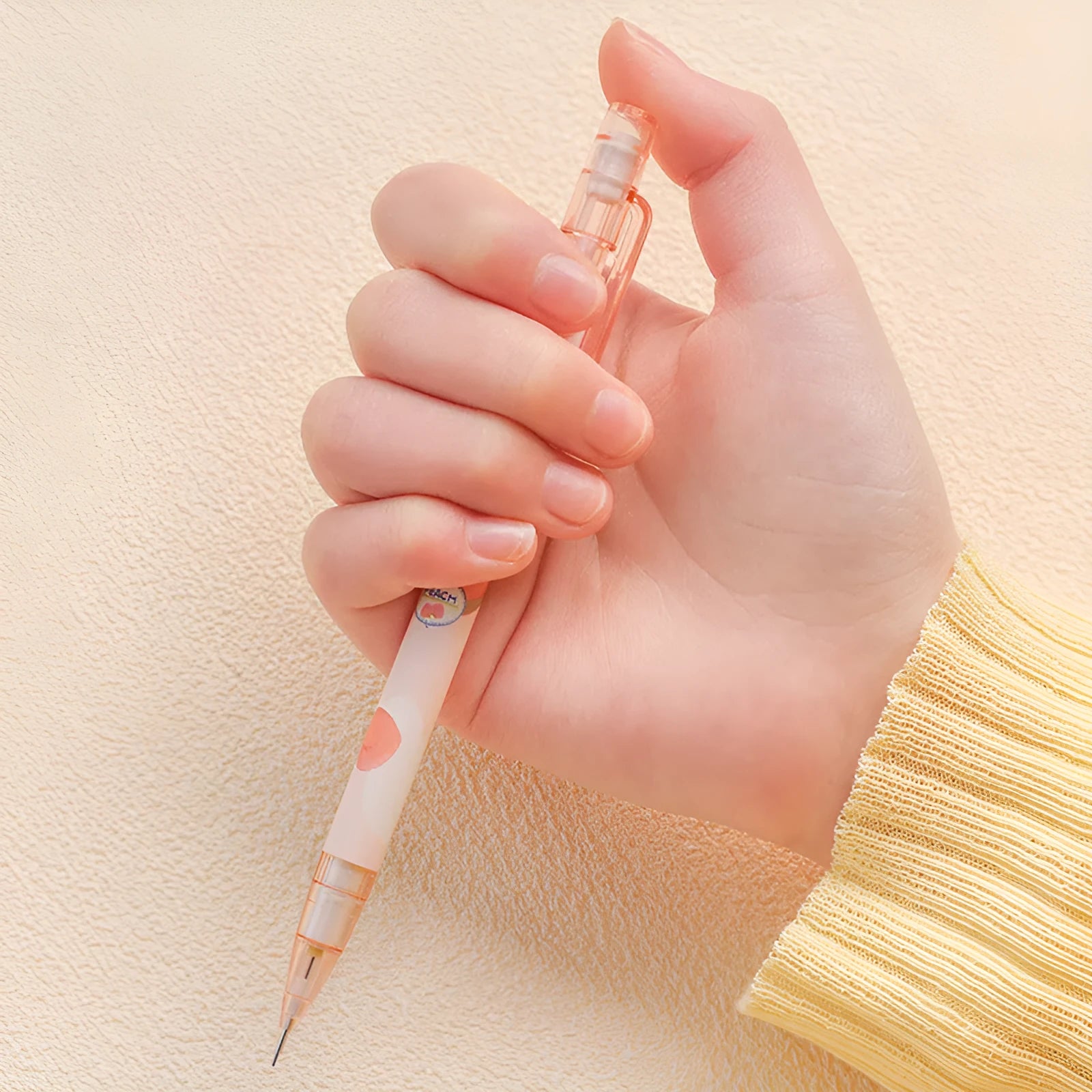 Automatic pencil press 0.5mm no sharpening in peach colour with plastic body and refills