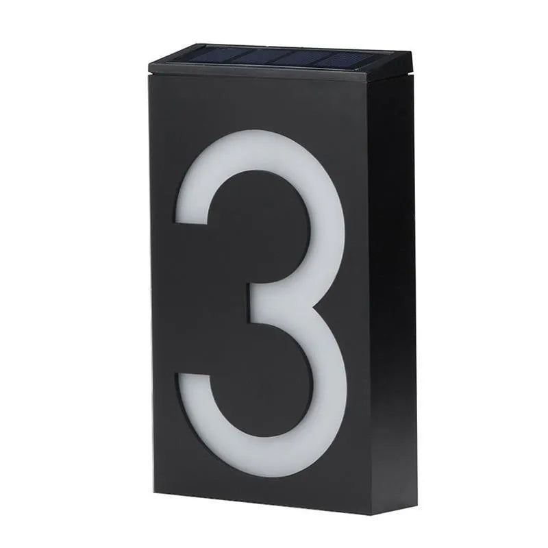 White solar-powered outdoor house number light with visible solar panel and LEDs.