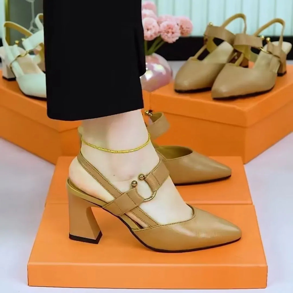Women's apricot coloured leather sandals with a closed toe, open back, and a chunky high heel.