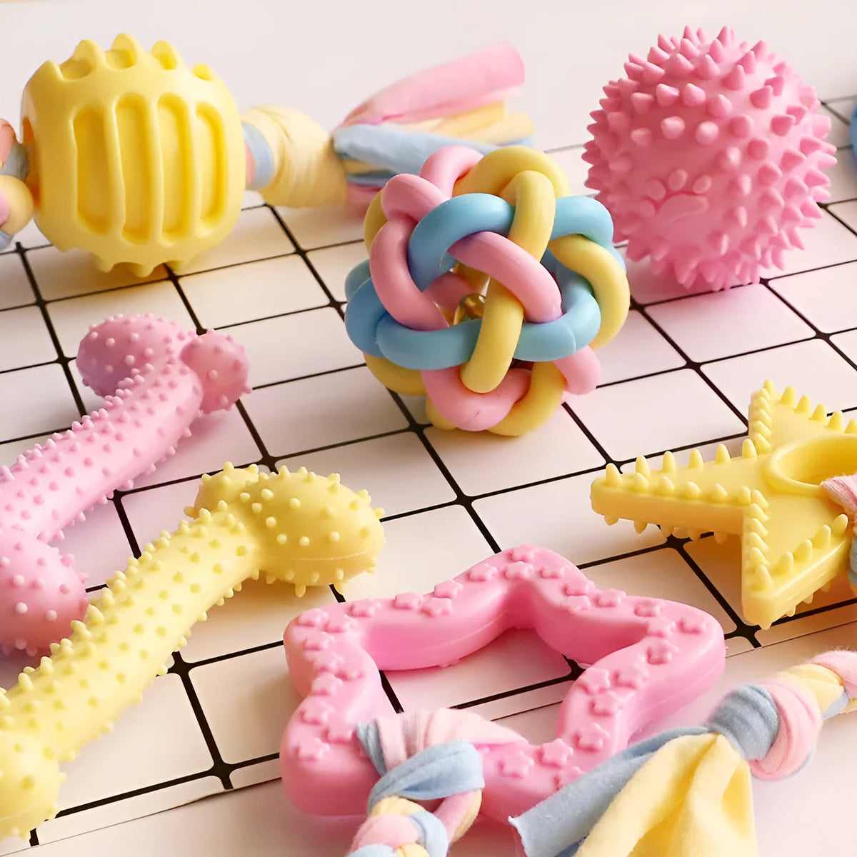 Non-toxic rubber dog chew toy with surface particles, star ring ball shapes, pink blue yellow