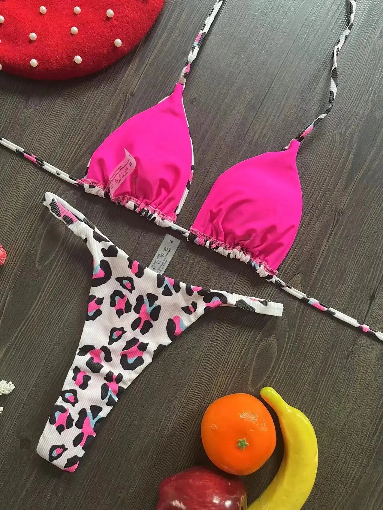 Women's printed bikini swimsuit on a hanger, showing briefs style with quick-drying fabric and cotton lining.